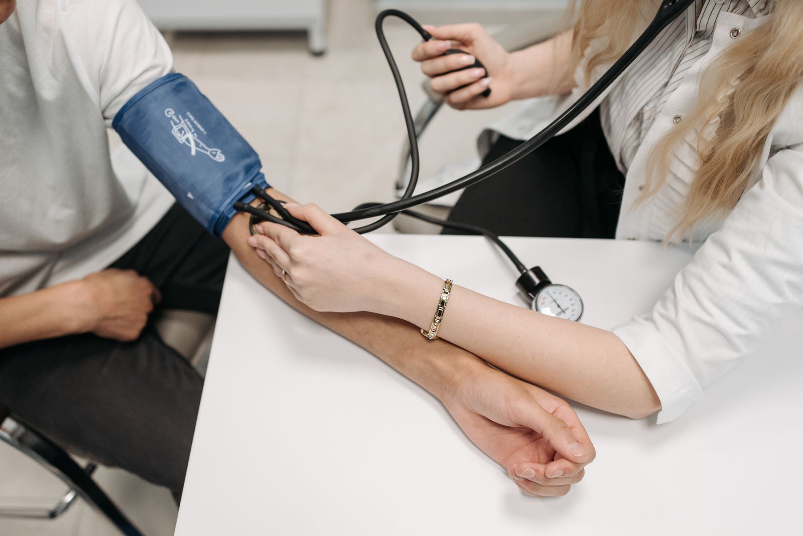 Cardiologist speaking with a patient in a clinic exam room