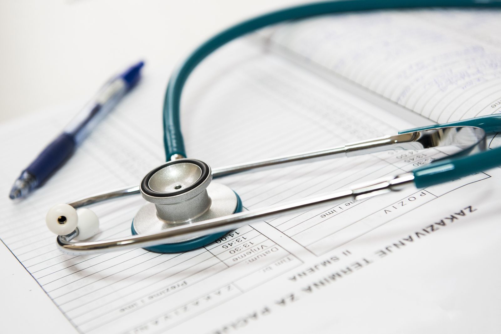 Physician writing clinical notes